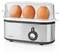 A stainless steel egg cooker with three brown eggs inside, covered by a clear plastic dome, on a white background.