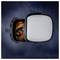 'Air fryer basket with cooked chicken and vegetables, viewed from above, with a closed lid nearby on a dark blue backdrop.'
