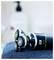 'Close-up of an electric shaver with three rotating heads, resting on a blue towel. Blurred bathroom items are in the background.'