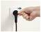 A hand is unplugging a black power cord from a wall socket, following the direction indicated by a blue arrow.