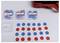 Red and blue counters arranged on a surface; additional counters in three transparent boxes labeled 'Wendeplättchen'.