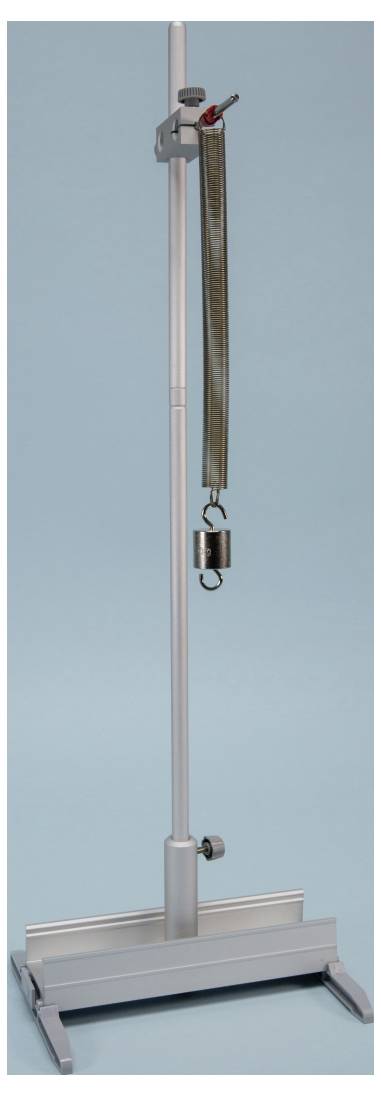 A tall, silver metal stand with an adjustable arm and a hook holding a weight, set against a plain background.