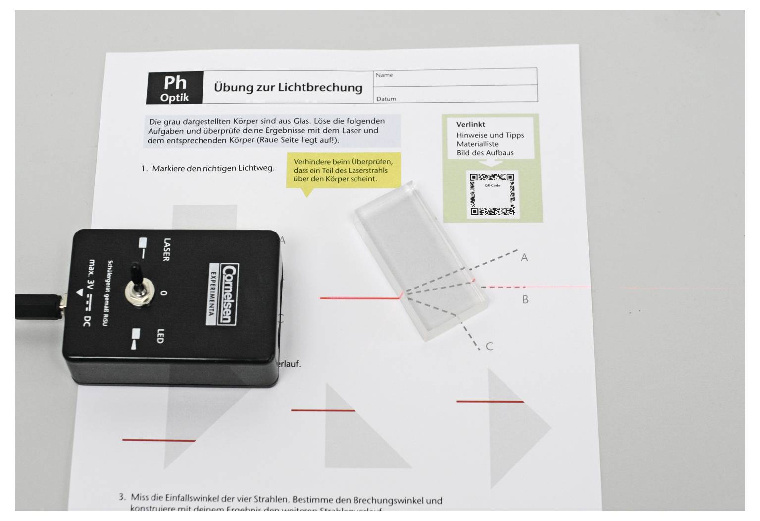 'Exercise on Light Refraction' sheet on a table with a light sensor. Includes instructions, a prism for refraction, and QR code for hints.