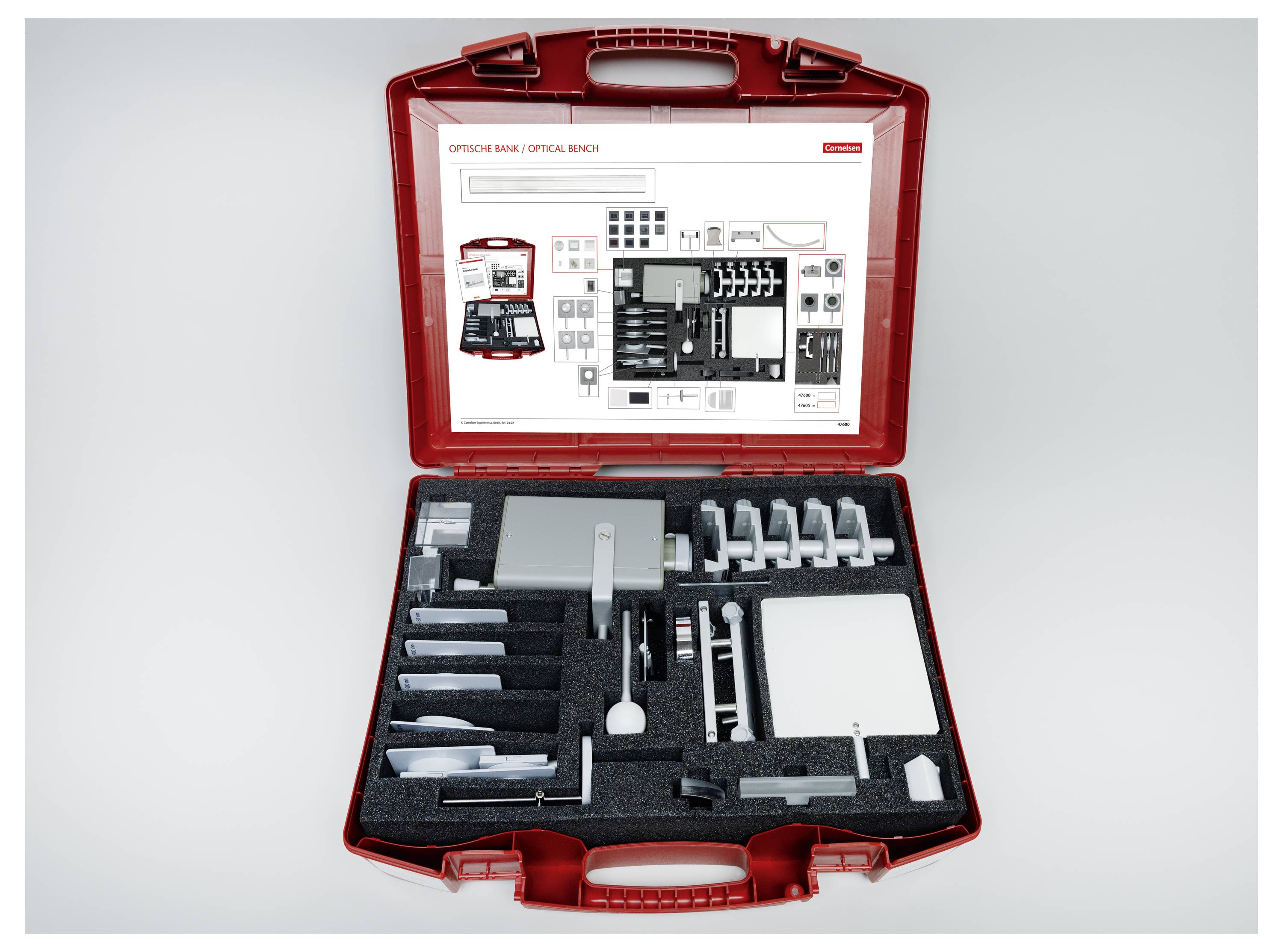 Open red toolkit showing assorted office equipment arranged neatly in foam compartments, including stamp pads, ink bottles, and a ruler.