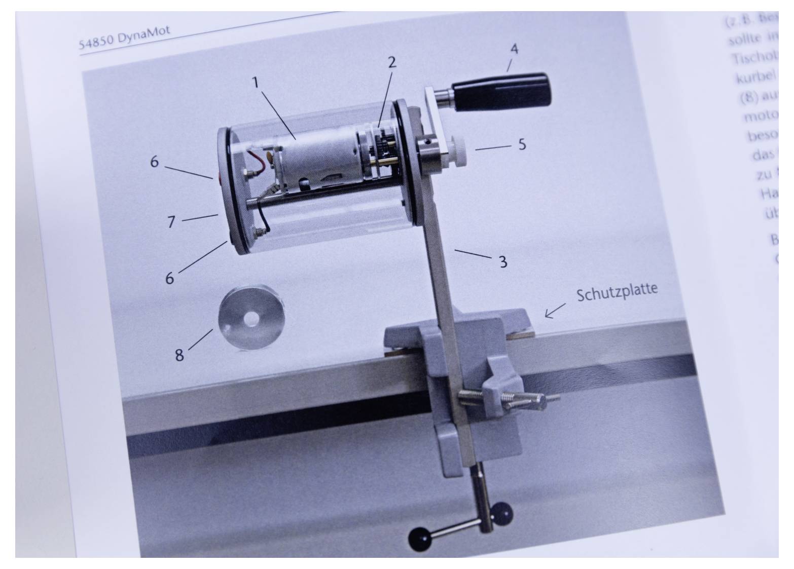 A cylindrical mechanical device with labeled parts (1-7), mounted on a stand, featuring an adjustable handle, and a 'Schutzplatte'.