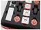 A set of red and black toy wheels and parts neatly organized in a foam packaging box.