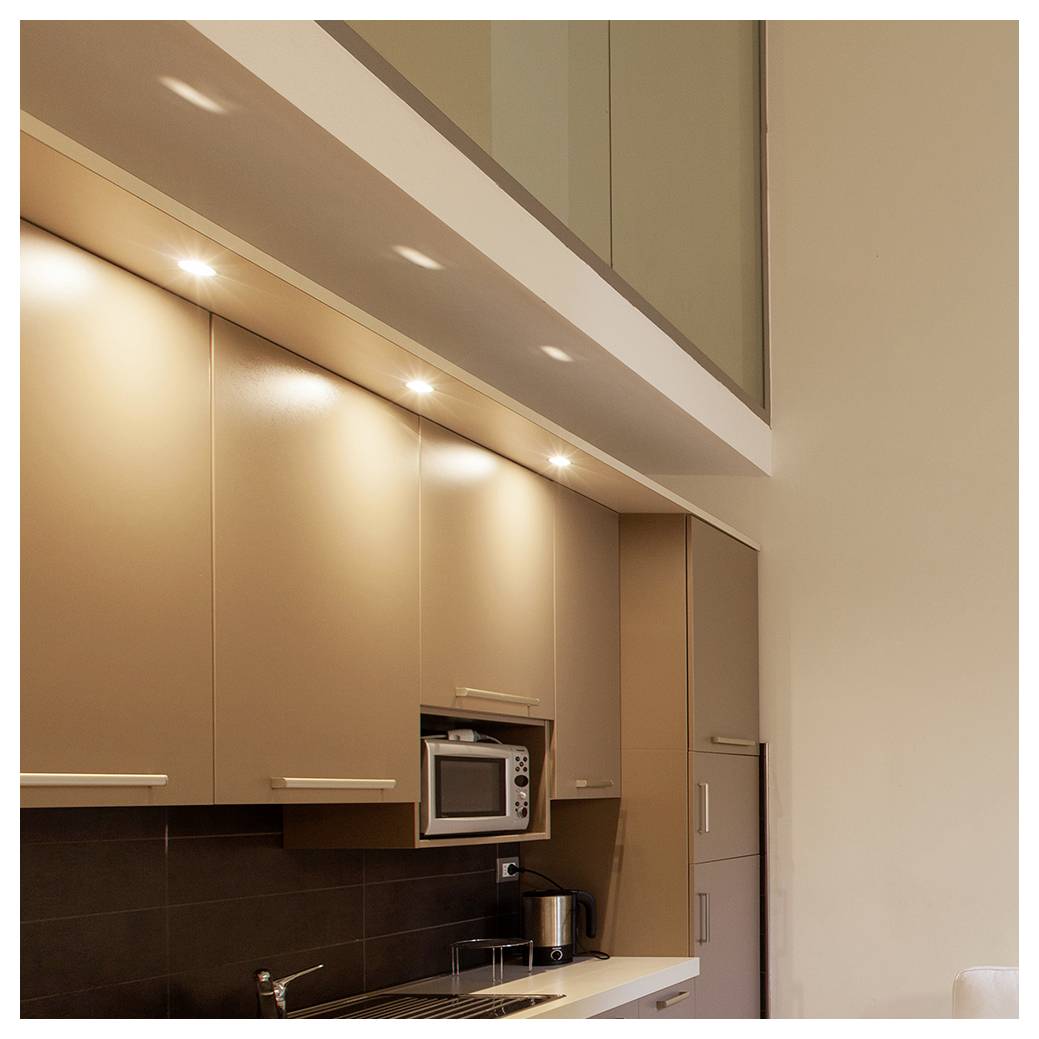 Modern kitchen with brown cabinets, built-in microwave, and a sleek countertop under recessed lighting. Minimalist, clean design.