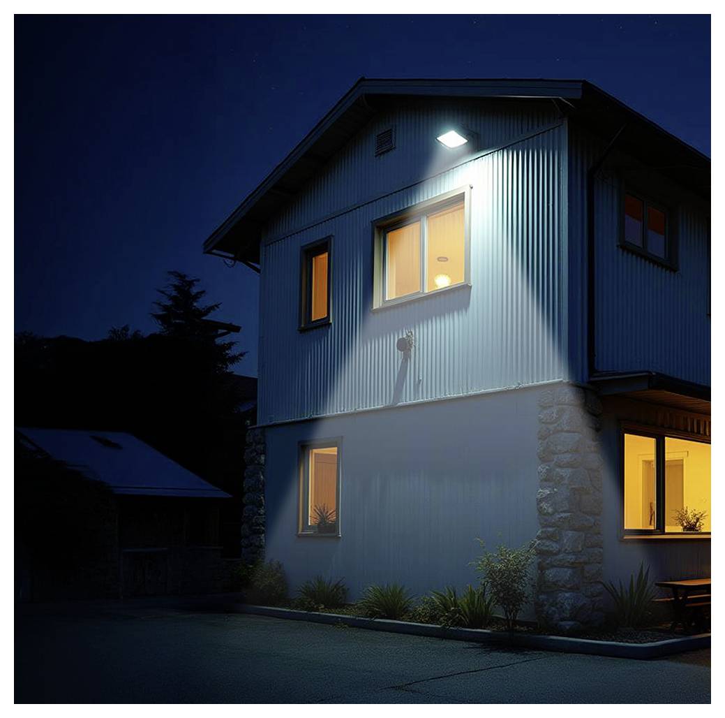 A two-story house with illuminated windows and an exterior light shines above, suggesting nighttime. The setting is quiet and residential.