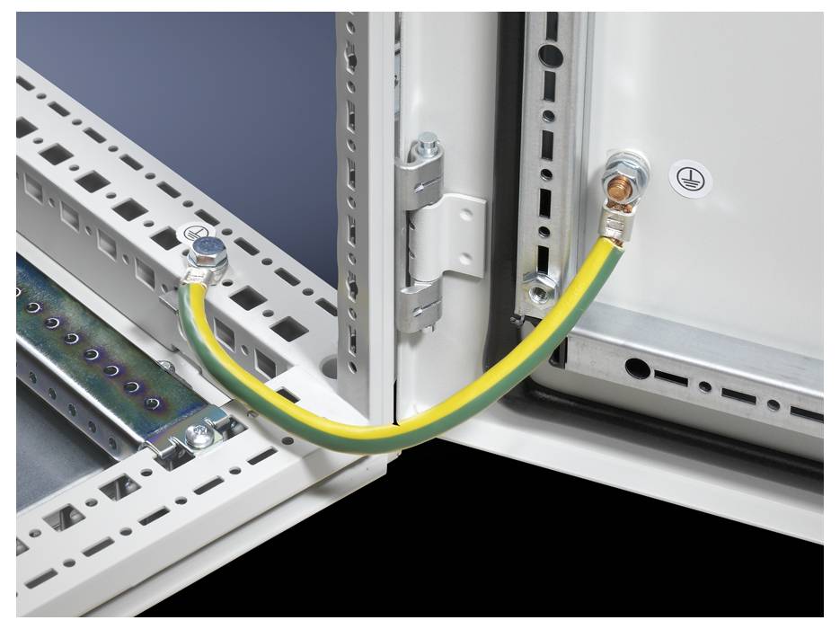 A yellow and green grounding wire connects two metal panels, ensuring electrical safety in an industrial control panel setup.