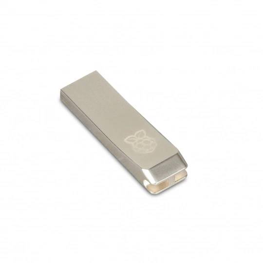 A metallic USB flash drive with a Raspberry Pi logo engraved on it, shown on a plain white background.
