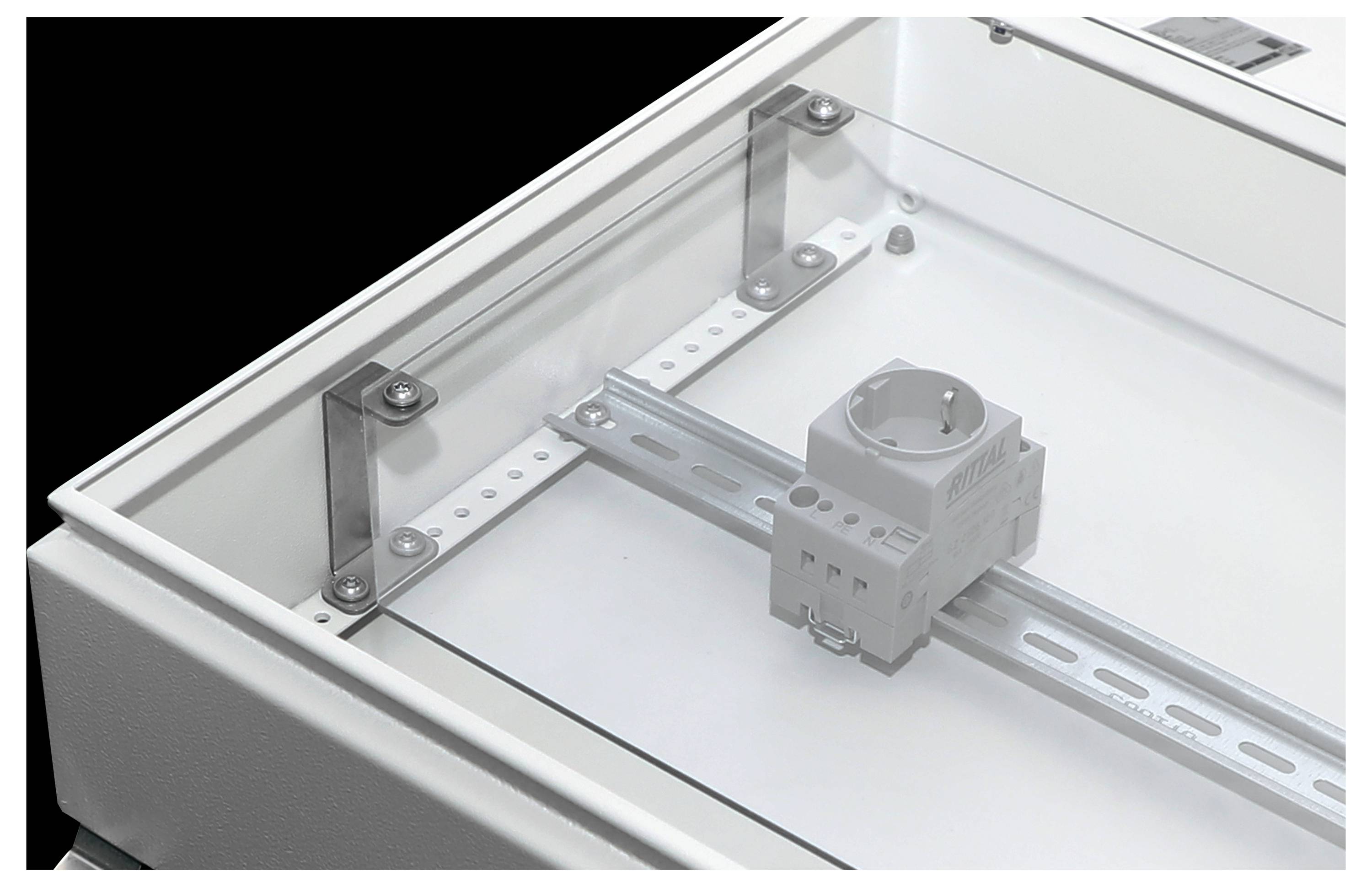 Interior of an electrical enclosure showcasing a mounted DIN rail with a single socket module, highlighting assembly setup.