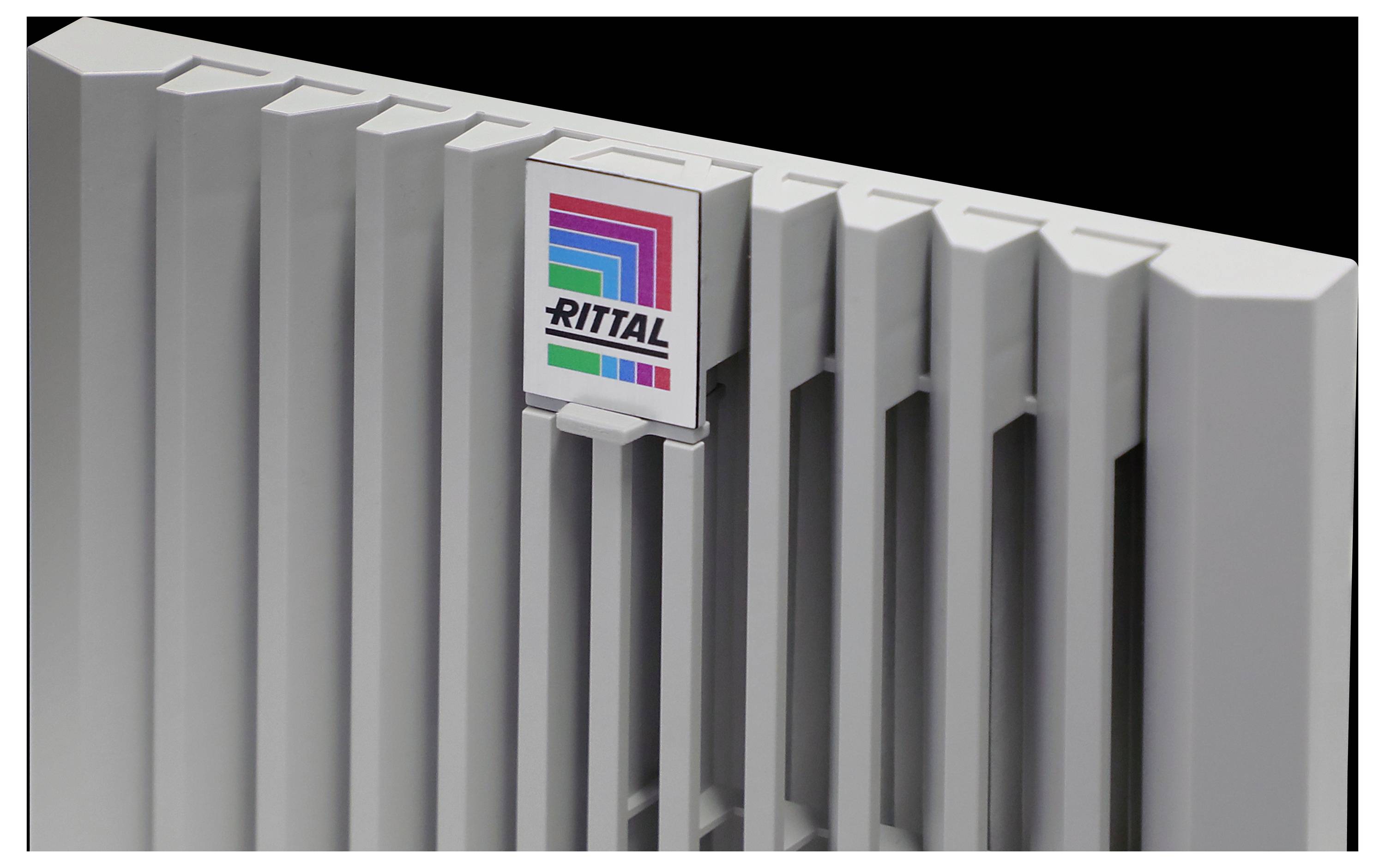A close-up of a gray Rittal enclosure panel with vertical vents and the Rittal logo featuring multicolored stripes on a dark background.