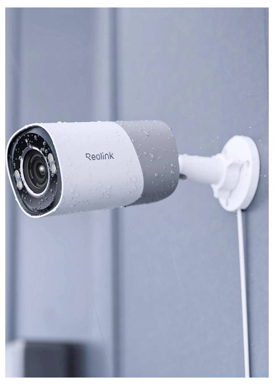 A mounted Reolink security camera with multiple lenses, covered in raindrops, on a wall.