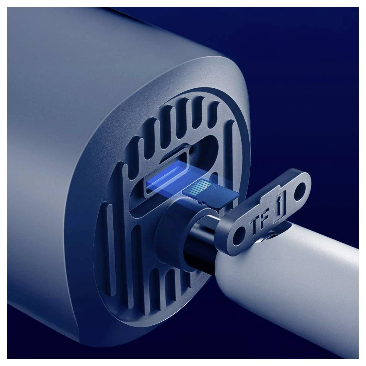 A USB stick is being inserted into a portable speaker, indicating connectivity or data transfer capability.