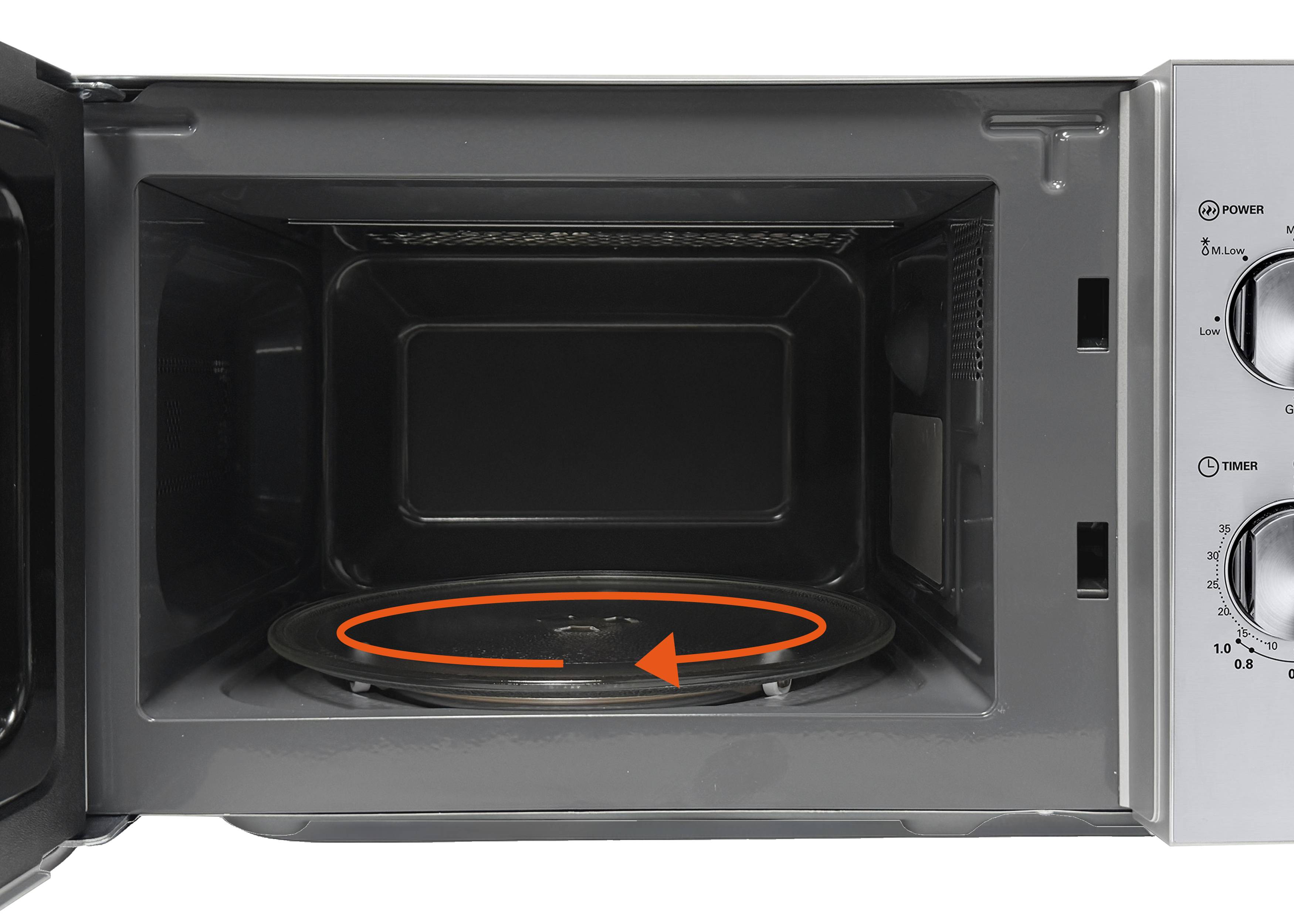 An open microwave with visible control knobs and an empty interior. An arrow indicates the rotating motion of the turntable inside.