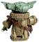 A detailed Lego figure of a character with green ears and a brown robe. The figure is seen from the back, holding a small object.