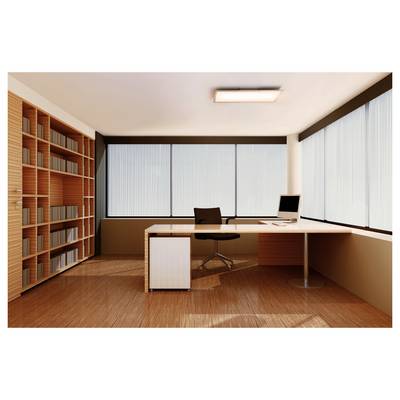A modern office with a large desk, chair, computer, and bookshelf. Large windows on two walls allow for natural light, enhancing the spacious feel.