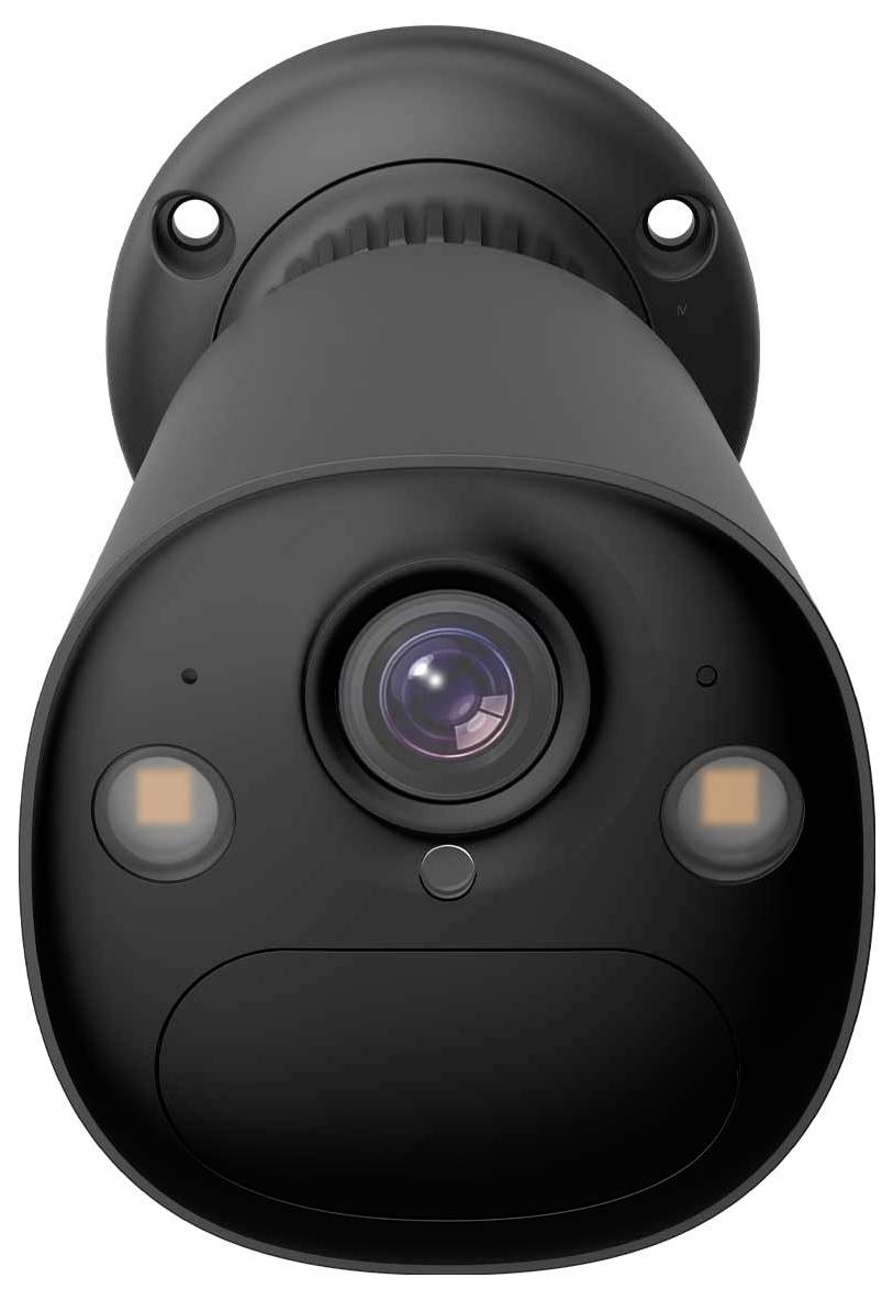 A black security camera with a lens in the center, mounted on a wall.