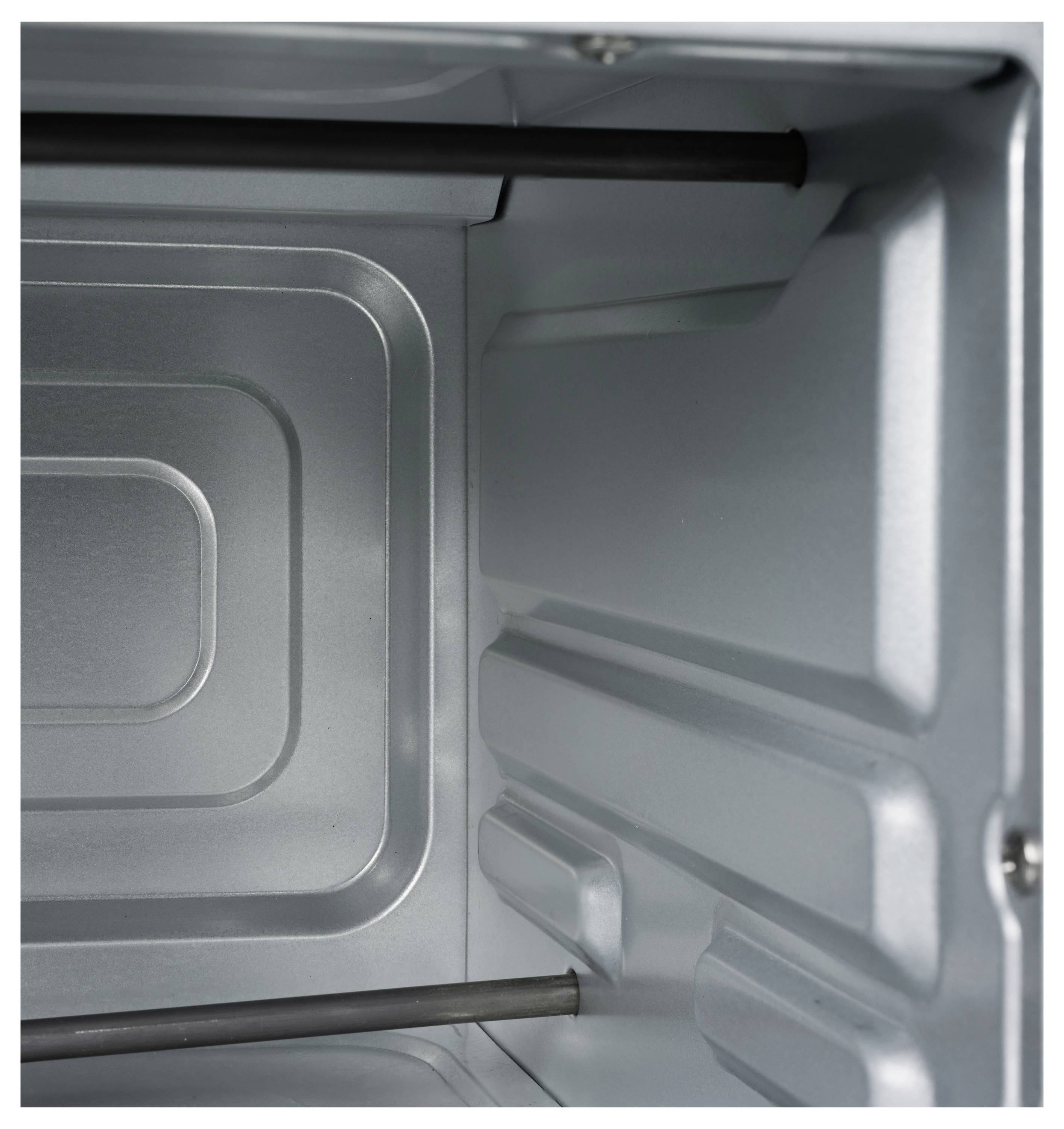 Interior of a stainless steel oven showcasing clean metal walls and heating elements.