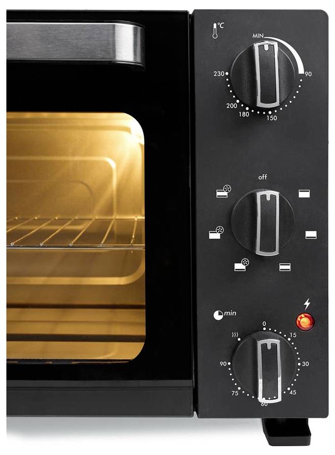 Compact black oven with temperature dial set at 180°C and a timer dial. The oven door is slightly open, showing the lit interior.