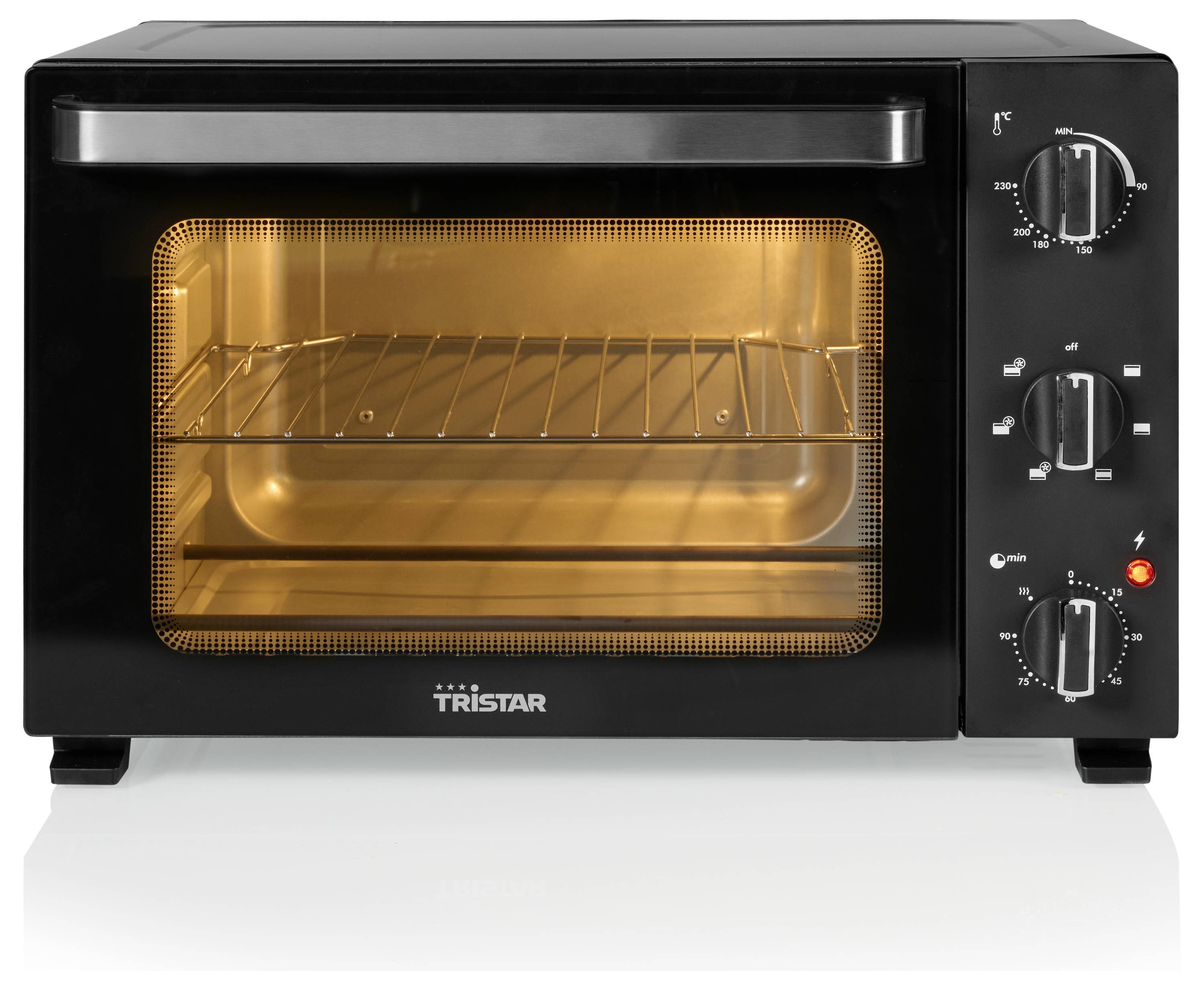 A black countertop oven with an illuminated interior shows a metal rack inside. Control knobs on the right indicate temperature settings.