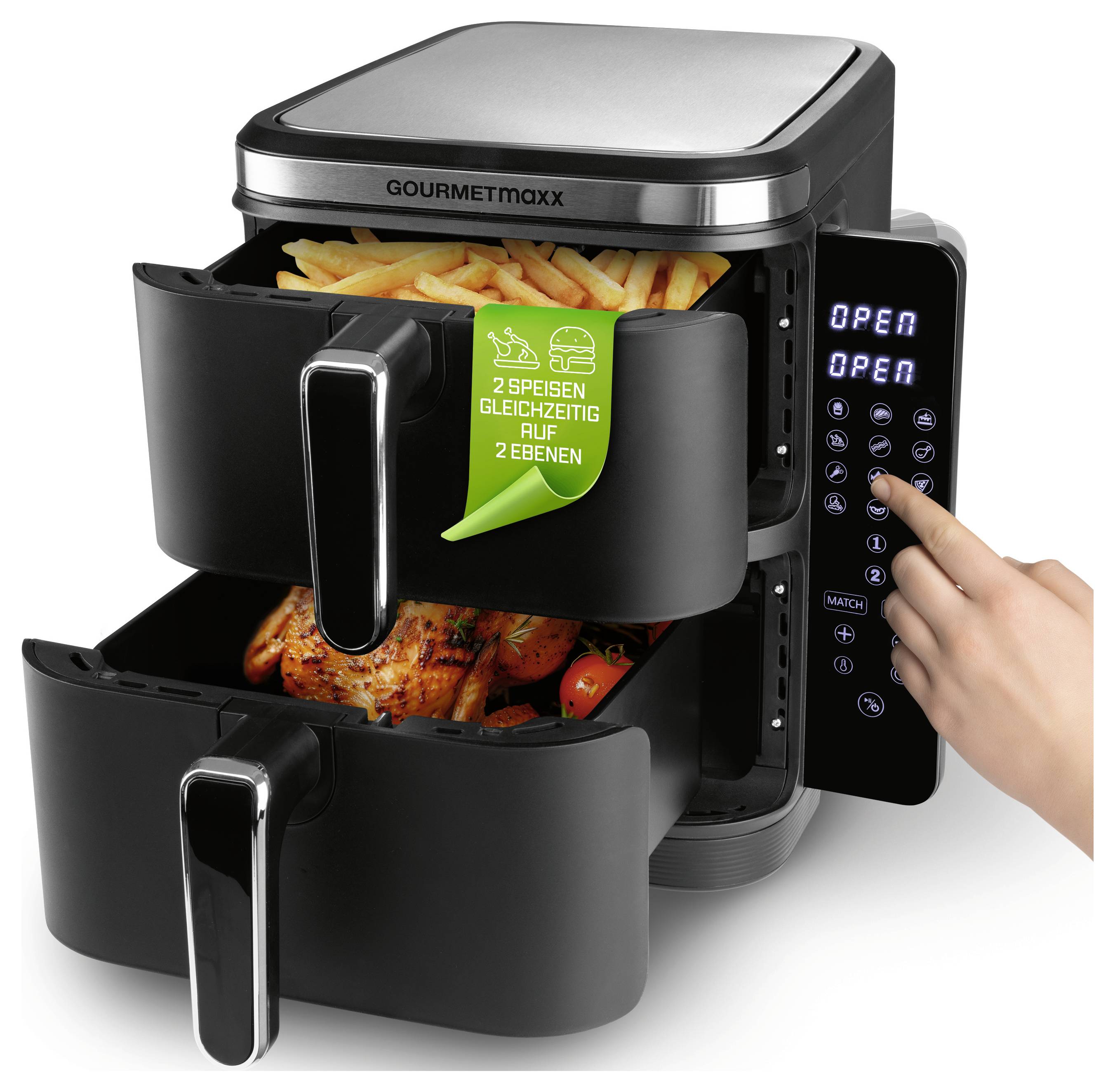 A dual-compartment air fryer with digital controls. The top drawer contains fries, and the bottom has a roasted chicken. A hand touches the control panel.