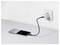 A smartphone charging on a white surface connected to a wall socket with a black cable, screen showing the time '17:25'.