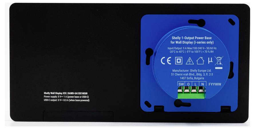 'Shelly 1-Output Power Base for Wall Display', blue circular panel with labeled connections, on a black base. Manufacturer: Shelly Europe Ltd.