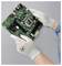Hands wearing anti-static gloves hold a computer motherboard against a gray background, highlighting safety in handling electronic components.