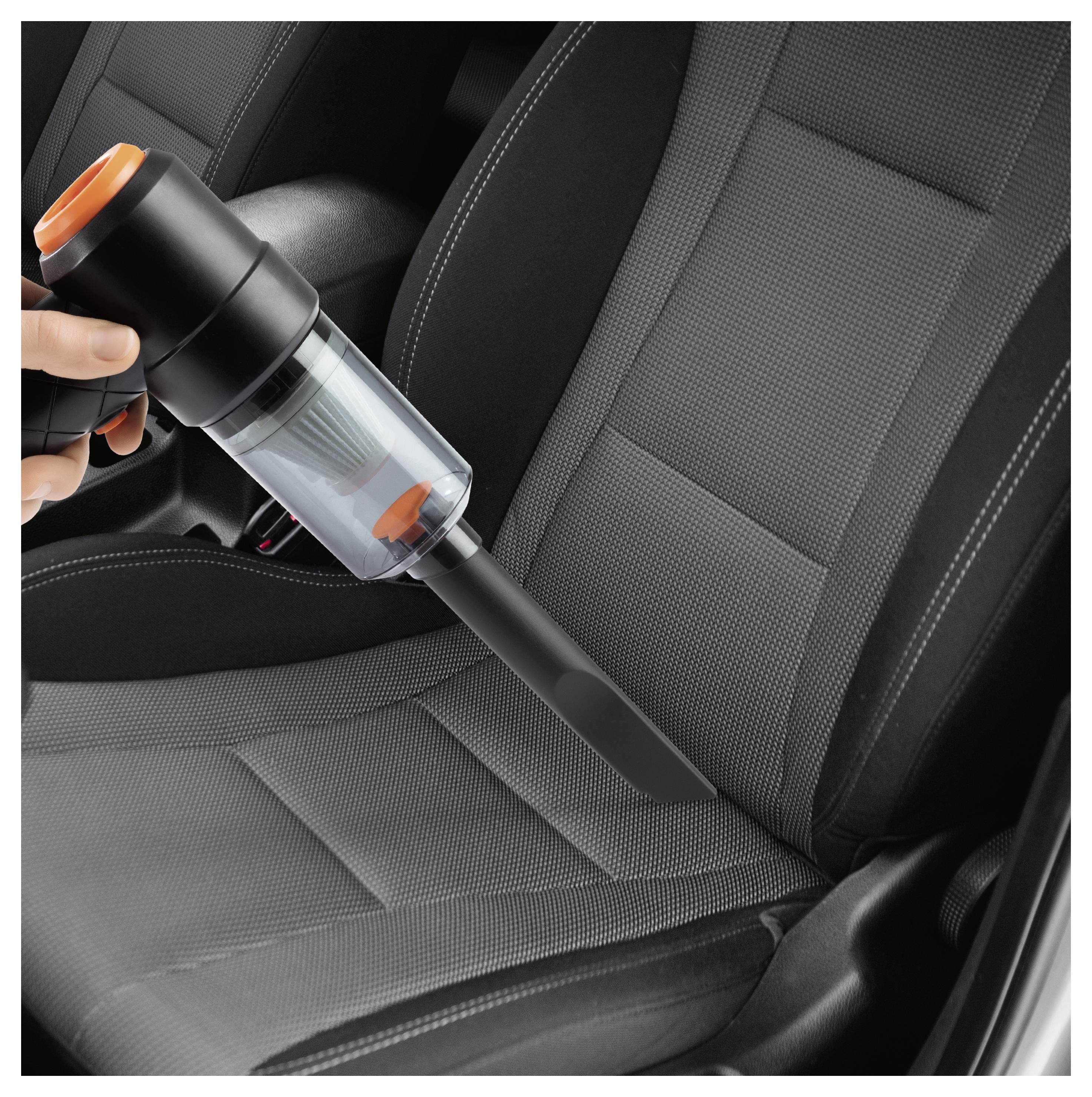 'A person uses a handheld vacuum cleaner on a car seat, emphasizing its portability and effectiveness in cleaning vehicle interiors.'