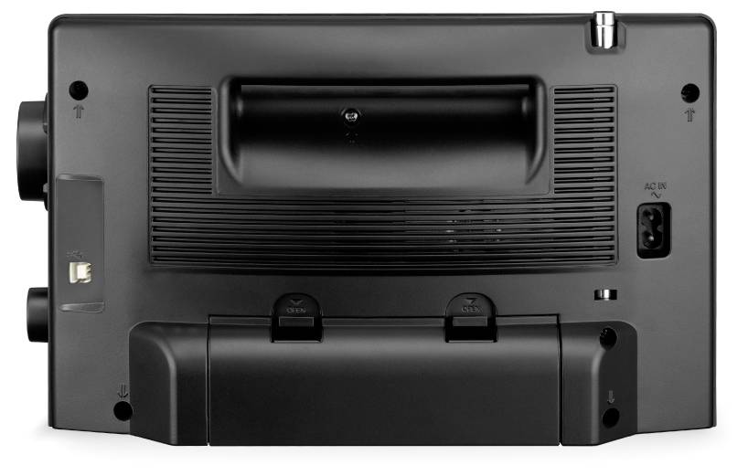 The image shows the rear view of an electronic device with multiple ports, including an auxiliary input and power connector.