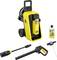 A yellow and black Kärcher K5 pressure washer with wheels, hose, spray gun, detergent bottle, and nozzle attachments, displayed against a white background.