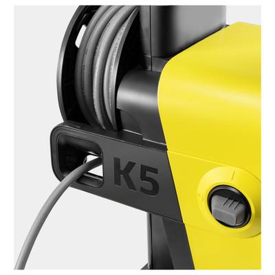 A yellow and black pressure washer with 'K5' on the side and a hose coiled on top.