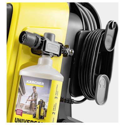 A yellow pressure washer with a coiled black hose and a universal detergent bottle attached. The bottle displays an image of a person using the washer.