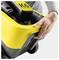 A person is holding the handle of a yellow and black K6 pressure washer, highlighting its portability and design.