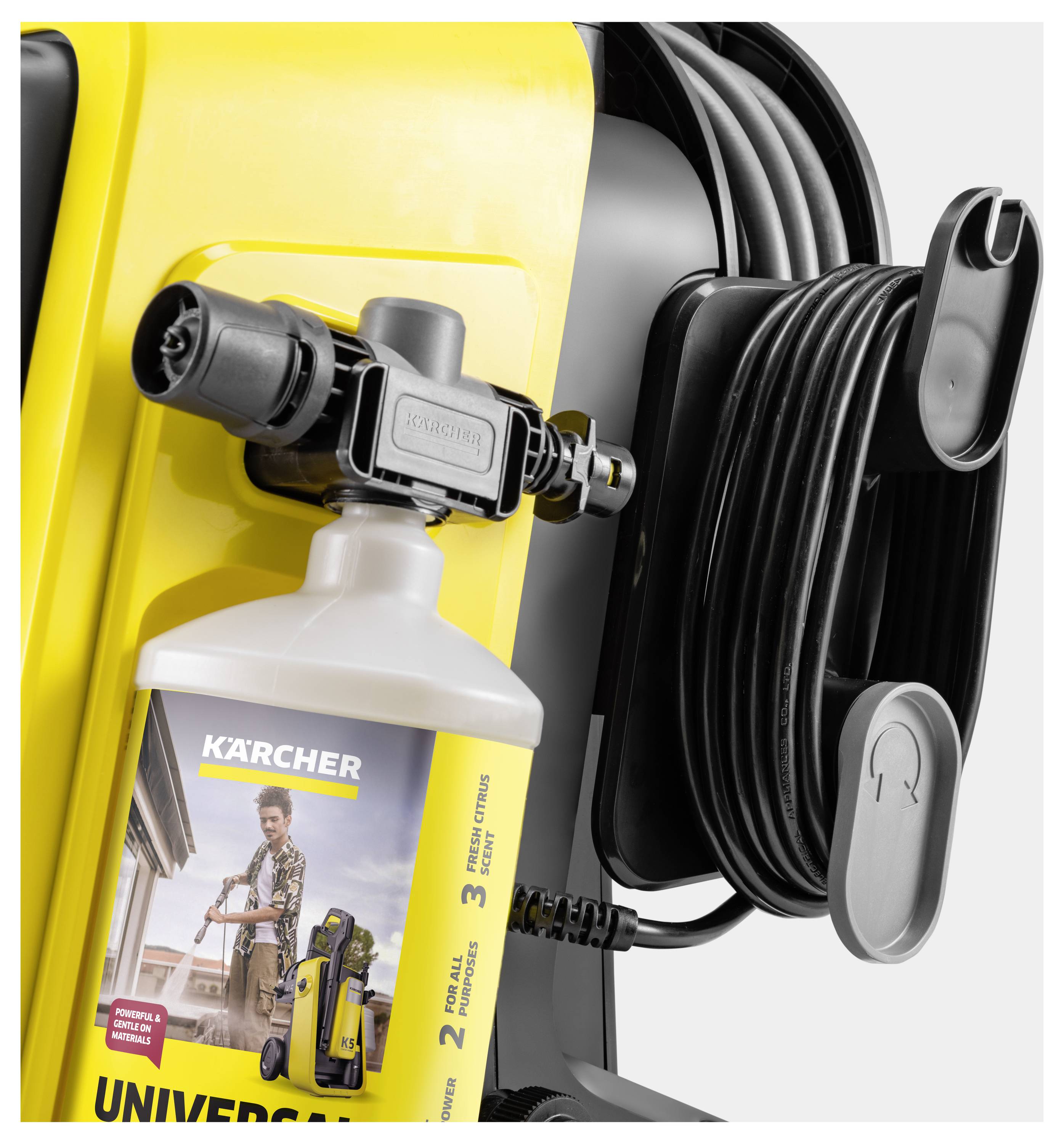 A pressure washer with attached hose and a bottle of detergent labeled 'Kärcher'. The image highlights the equipment setup.