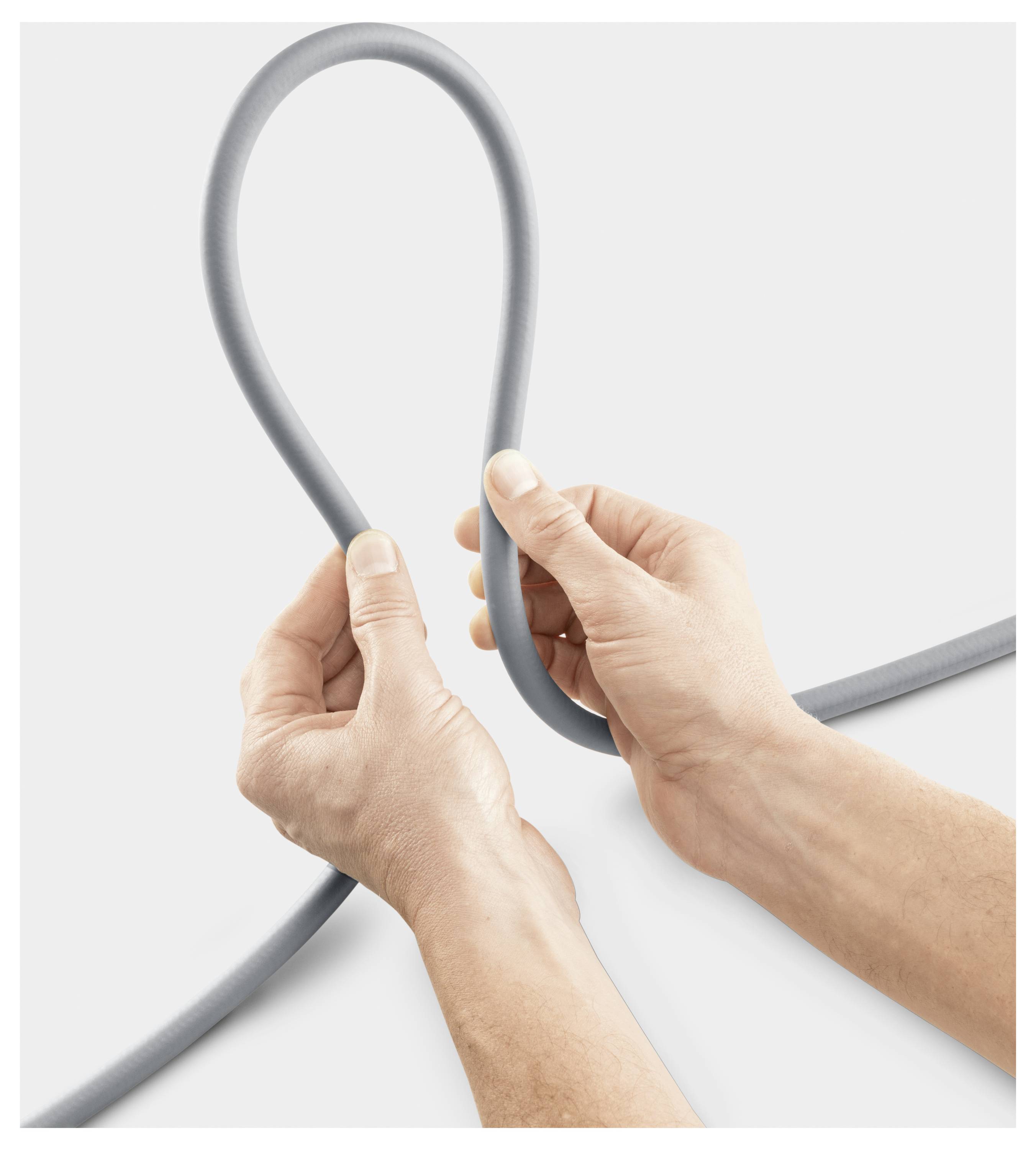 Hands holding and forming a loop with a grey rope against a plain background.