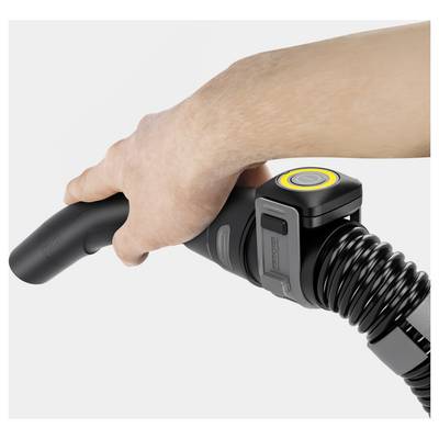 A hand holds a vacuum cleaner handle with a digital display and control button, illustrating modern cleaning technology.