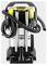 A commercial-grade vacuum cleaner with a robust design, featuring metal tubing, a yellow and black base, a large flexible hose, and storage compartments for attachments.