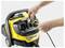 Hands connecting a cable to a yellow and black Kärcher cleaning machine, focusing on a detailed view of the front panel and interface.