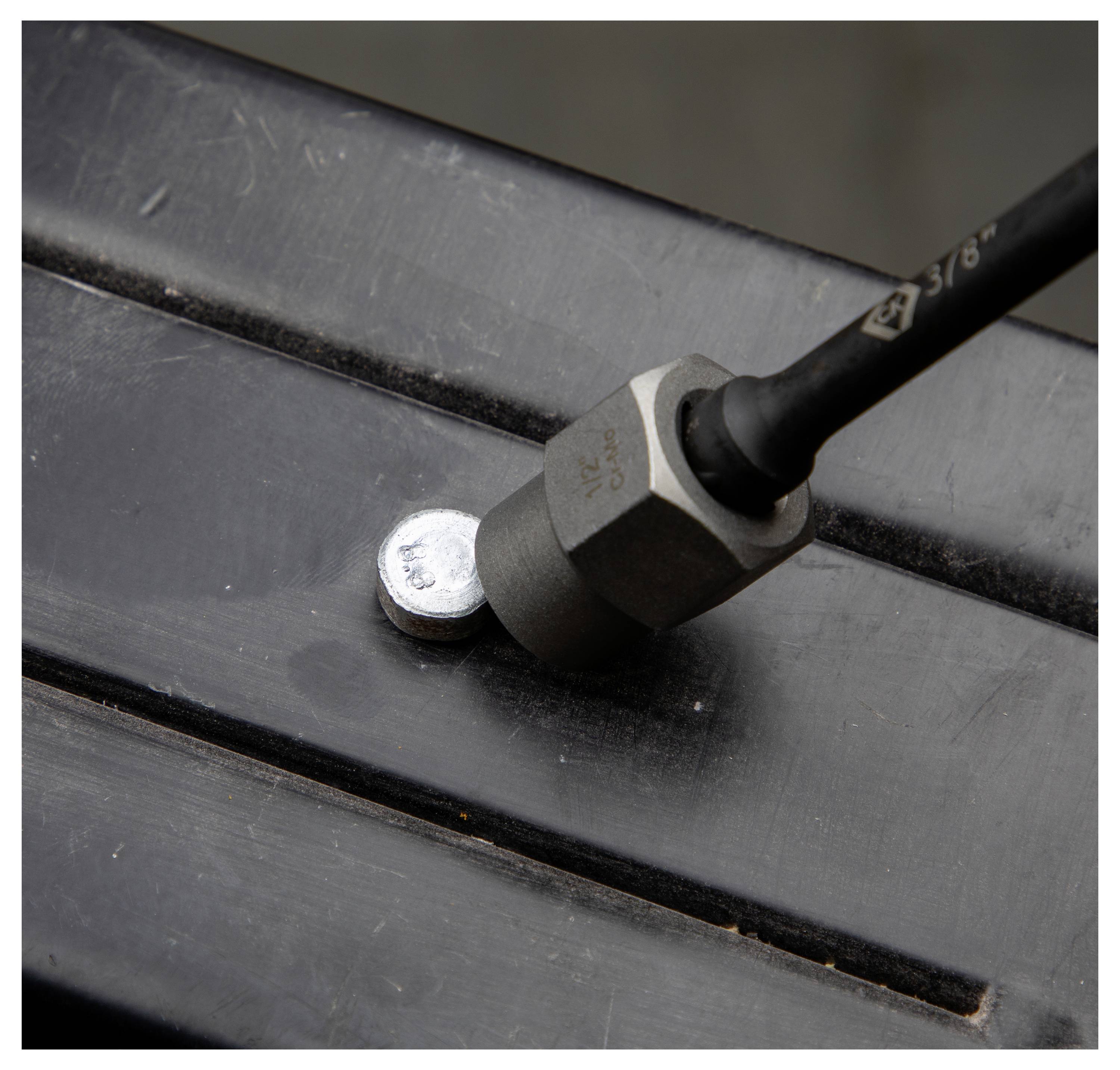 'A magnetic sensor detecting a metallic surface from close range, illustrated by a cylindrical magnet attached to the surface.'