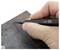 'Close-up of a hand holding a precision tool, marking a rusted metal surface, suggesting measurement or crafting in progress.'