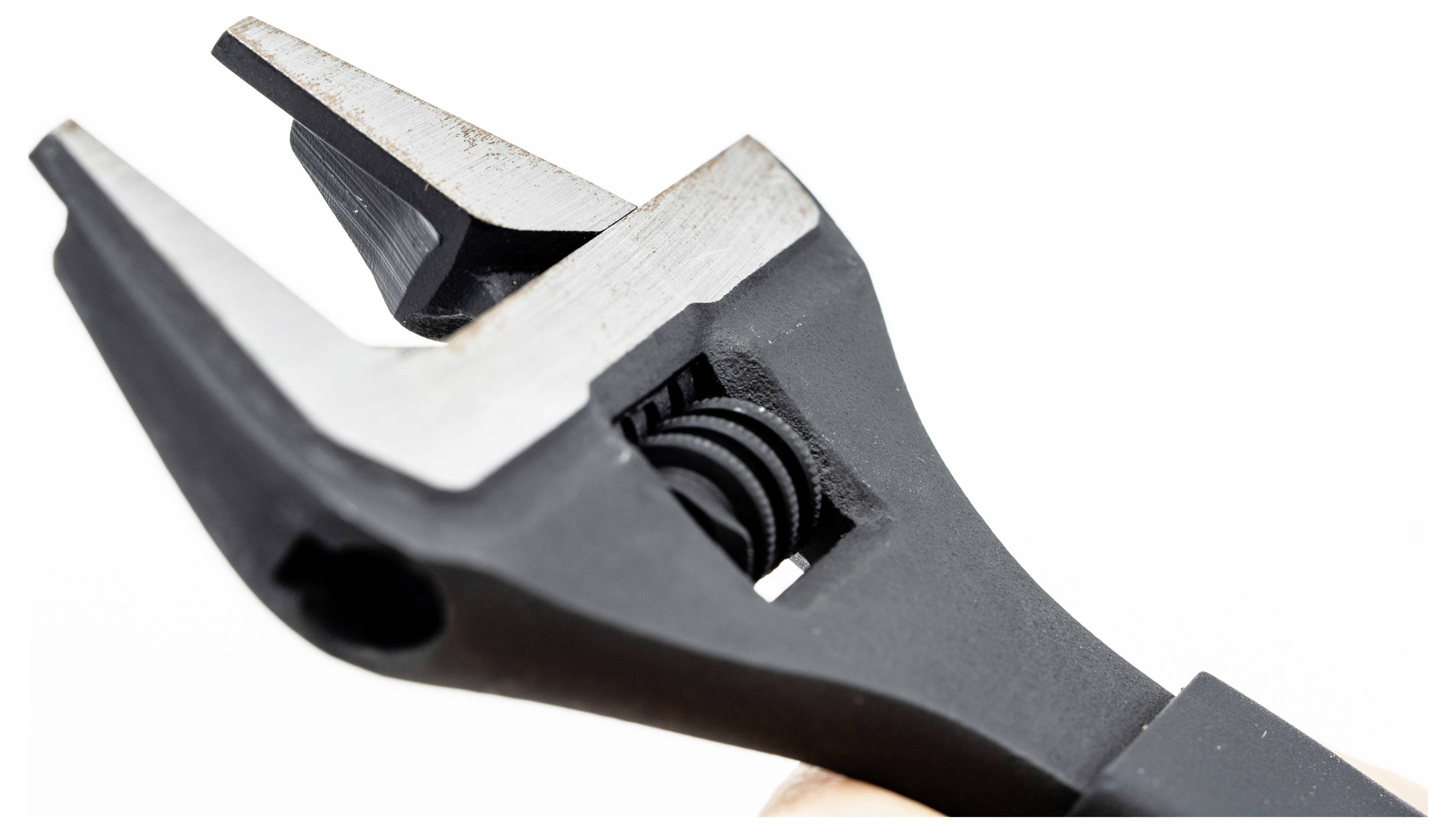An adjustable wrench with a black handle and metallic jaws, focused on the screw mechanism, set against a white background.