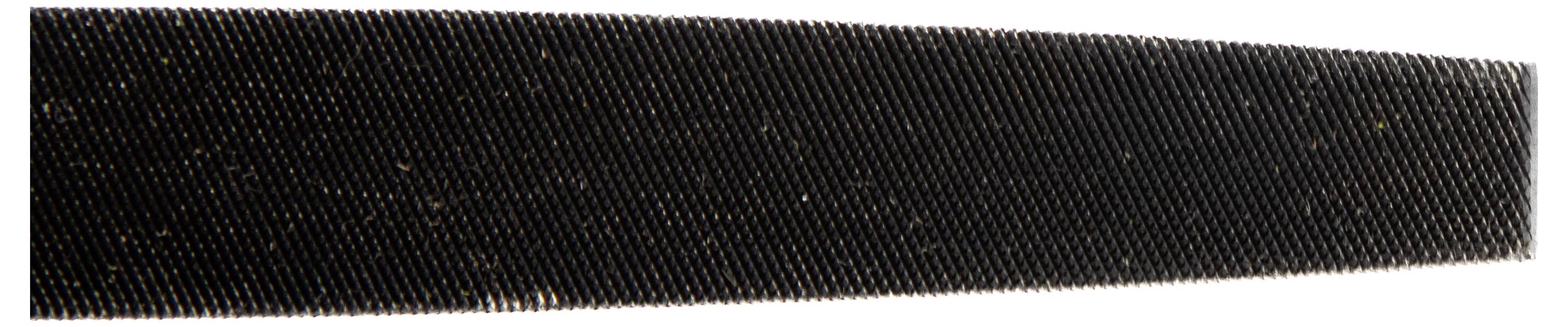 A close-up of a dark-colored, narrow, elongated object with fine ridges, appearing as part of a tool, possibly a file or rasp surface.