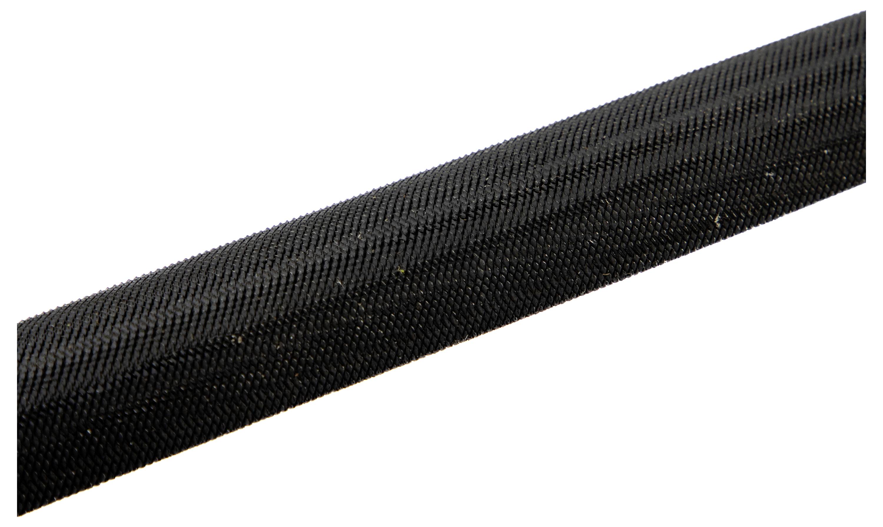 A close-up of a textured black grip, possibly from a handle or tool, showing its rough surface patterns.