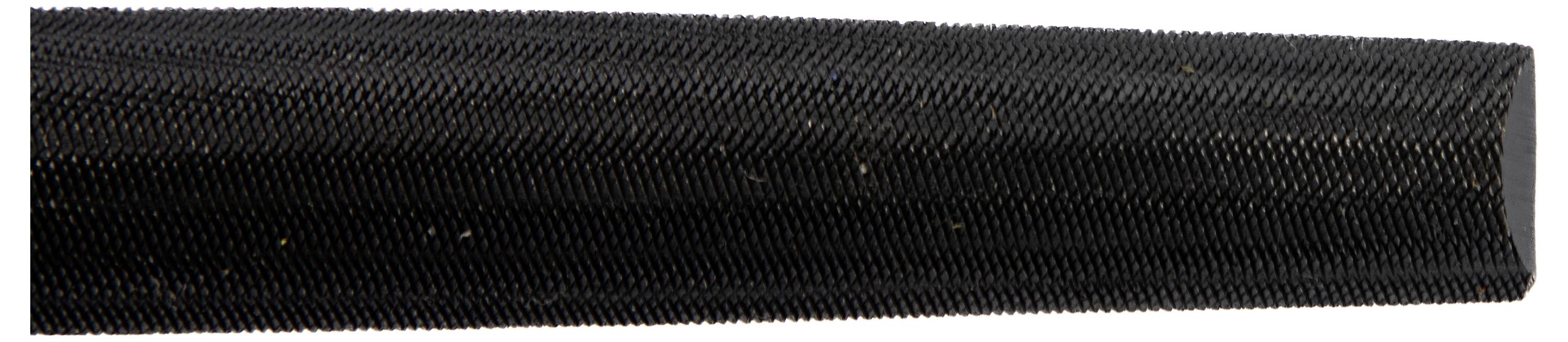 Close-up of a black textured tire surface with fine grooves and ribbed patterns, highlighting the tread detail.