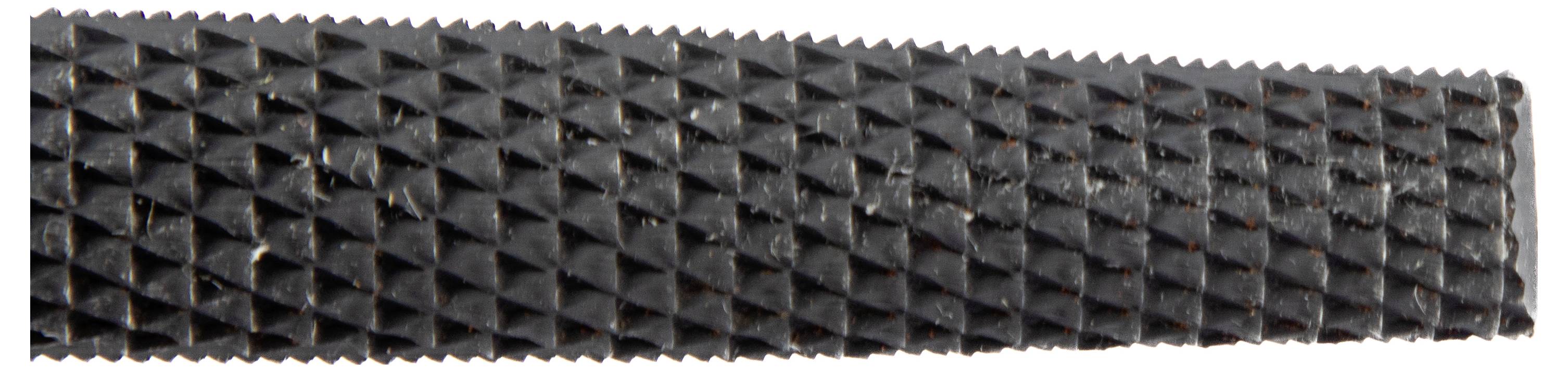 A close-up of a metal file with a diamond-patterned surface used for smoothing or shaping materials.