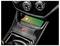 Smartphone charging wirelessly in a Subaru STI car console with carbon-fiber trim and STI badge.
