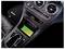 Car center console with wireless charging pad, climate controls, clock, air vents, and a gear selector; green phone charging indicator visible.