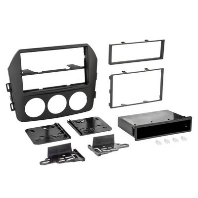 Disassembled black car stereo dash kit with mounting frames, three circular gauge openings, plates, brackets, and a single-DIN radio sleeve.